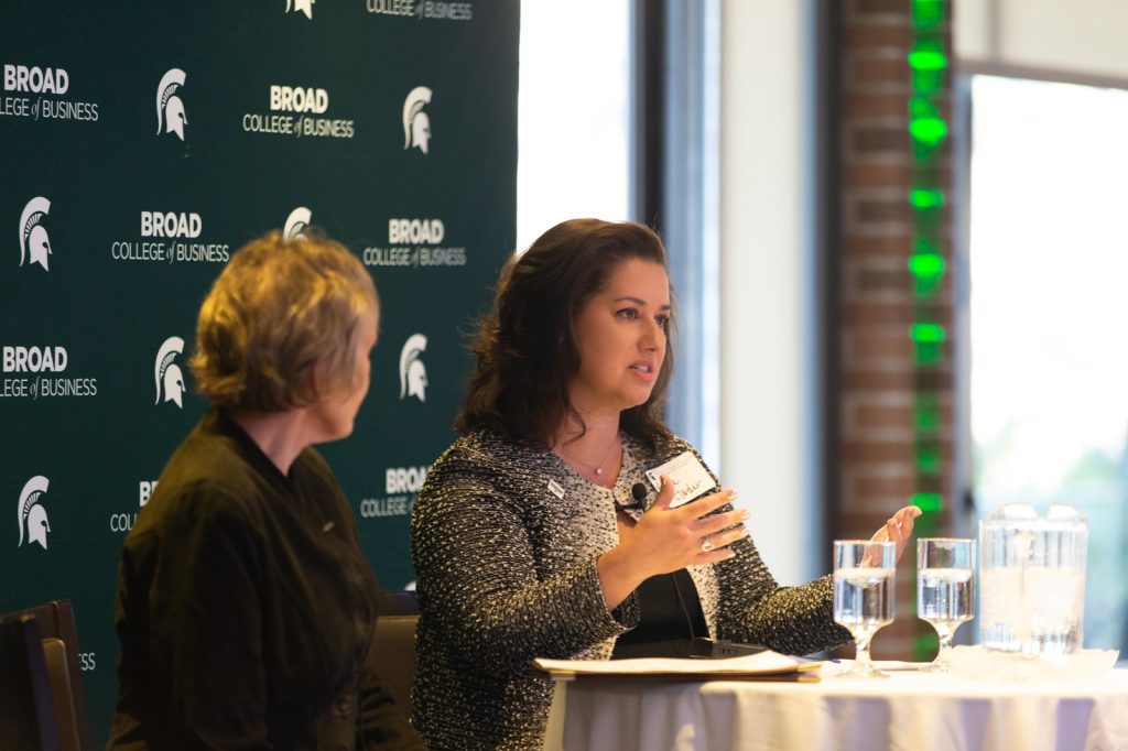 Advancing Women in Business panelists seated at a table, speaking.